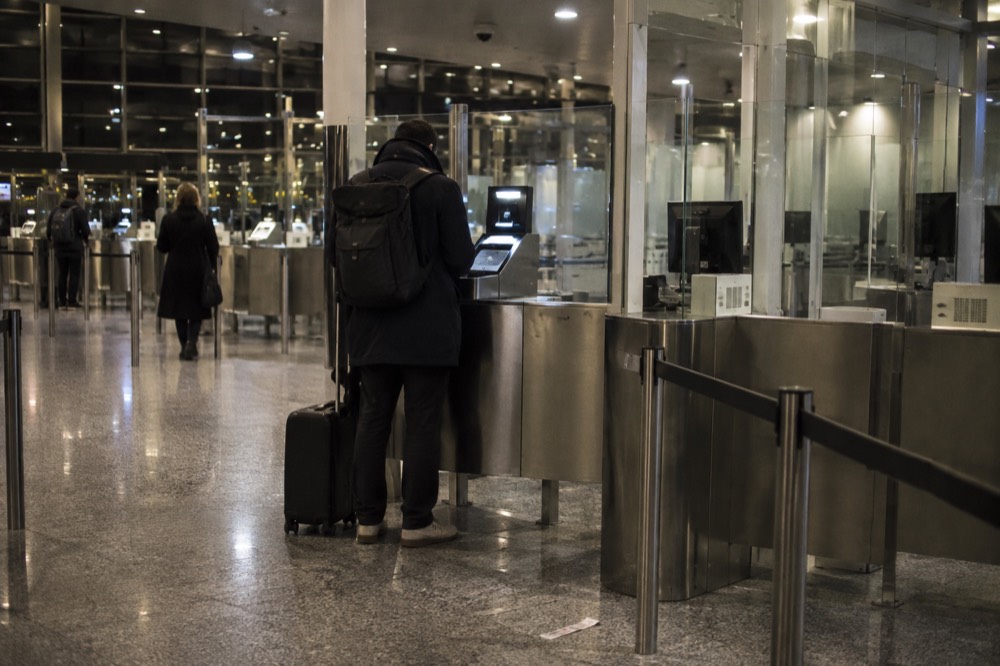 A biometric passport scanner at an airport border control desk