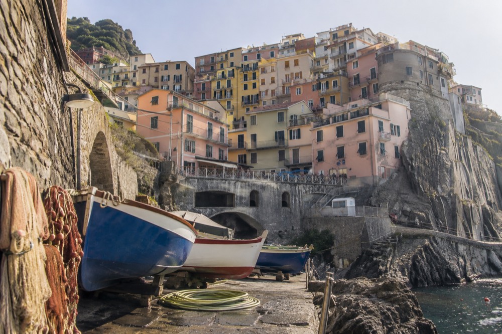Coastal Italian town with pastel buildings stacked above a harbour