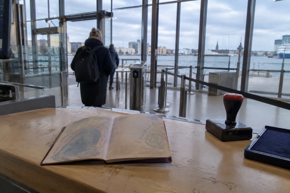 A passport held open at a European border control desk