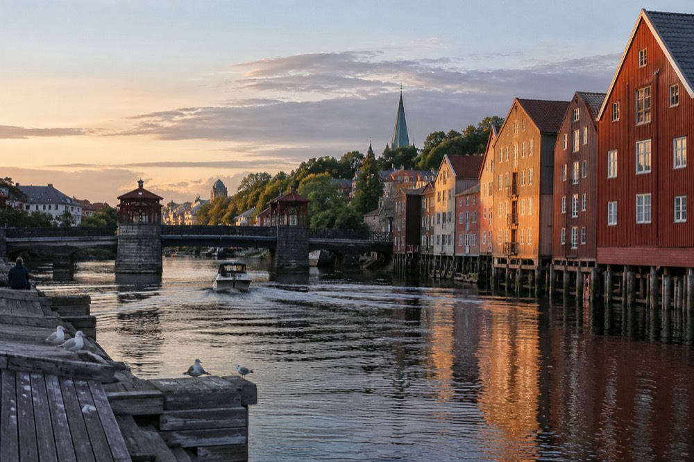 A wide stone bridge crossing a river between old city buildings