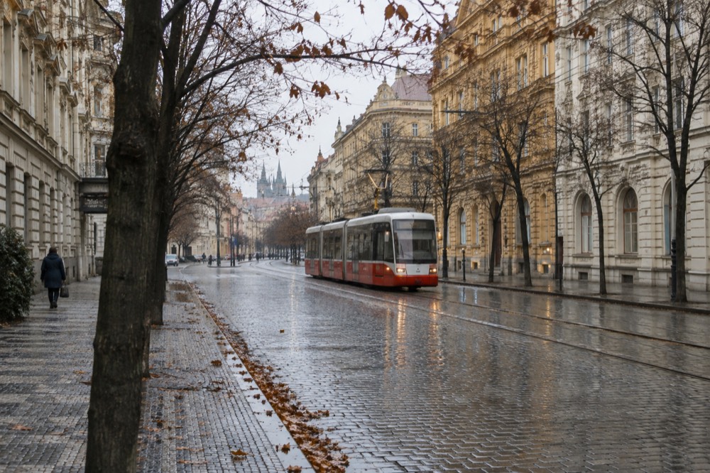 A wide boulevard with grand historic buildings and tram lines