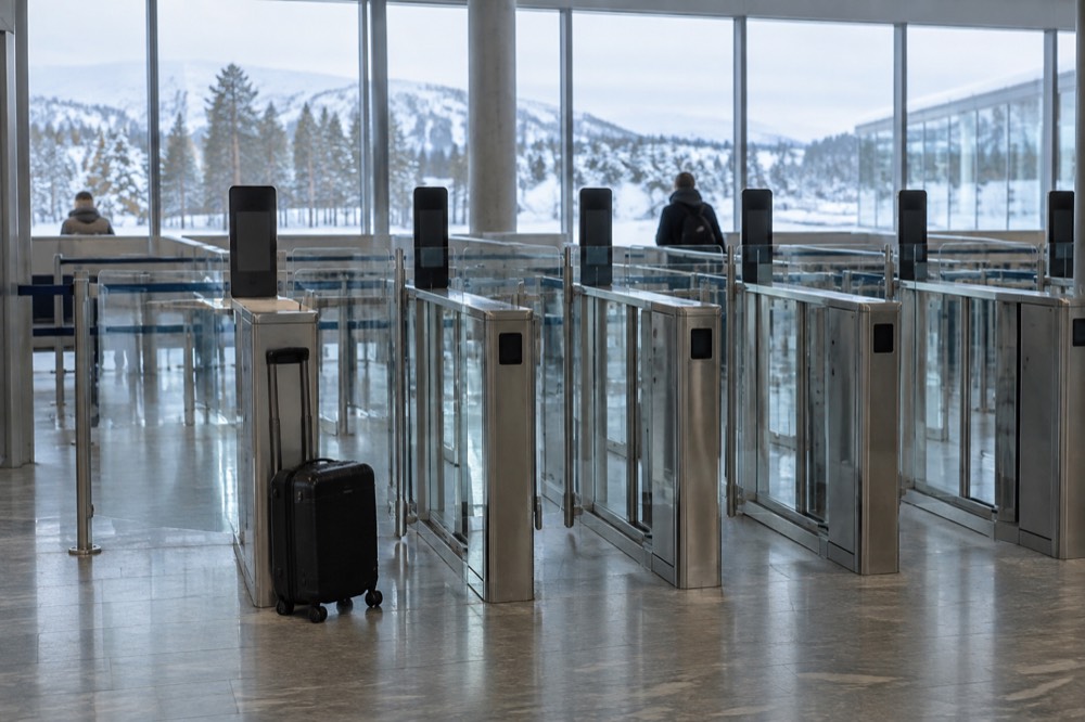 Passport control booths at a European airport border with electronic gates